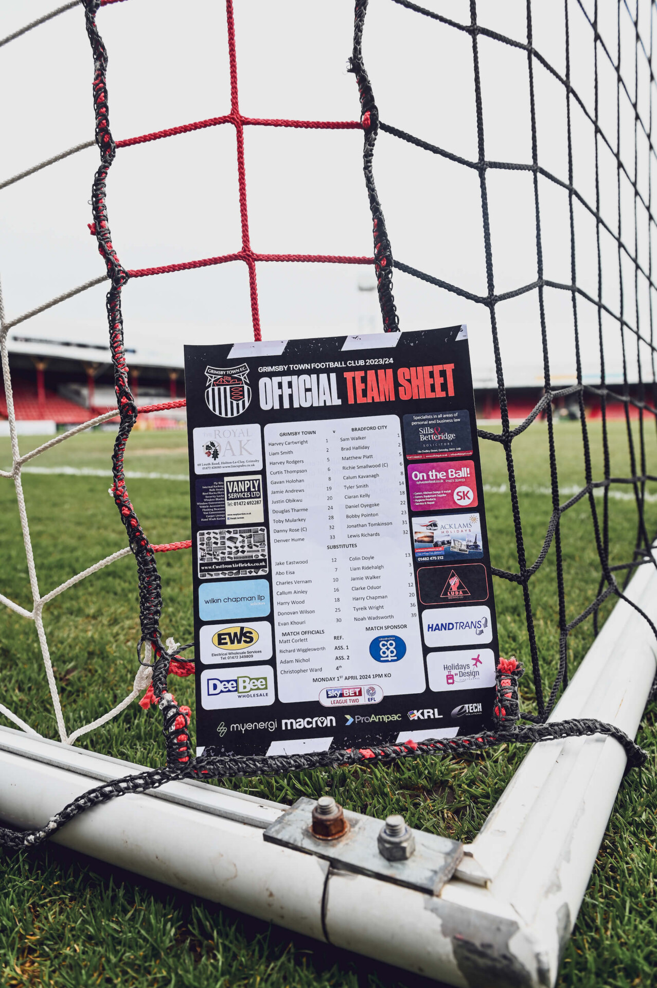 GTFC Official Team Sheet Flyer shown laid on the goal netting at Blundell Park