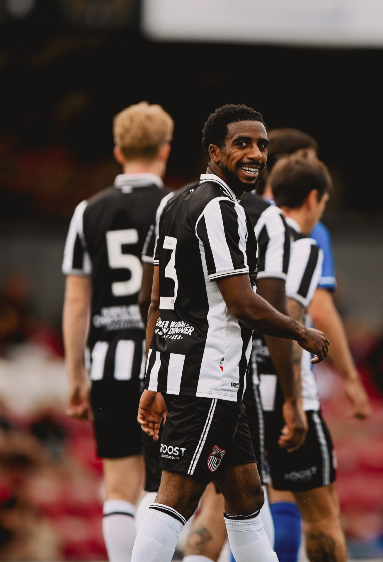 Jayden Sweeney on the pitch and Blundell Park. Smiling at the camera